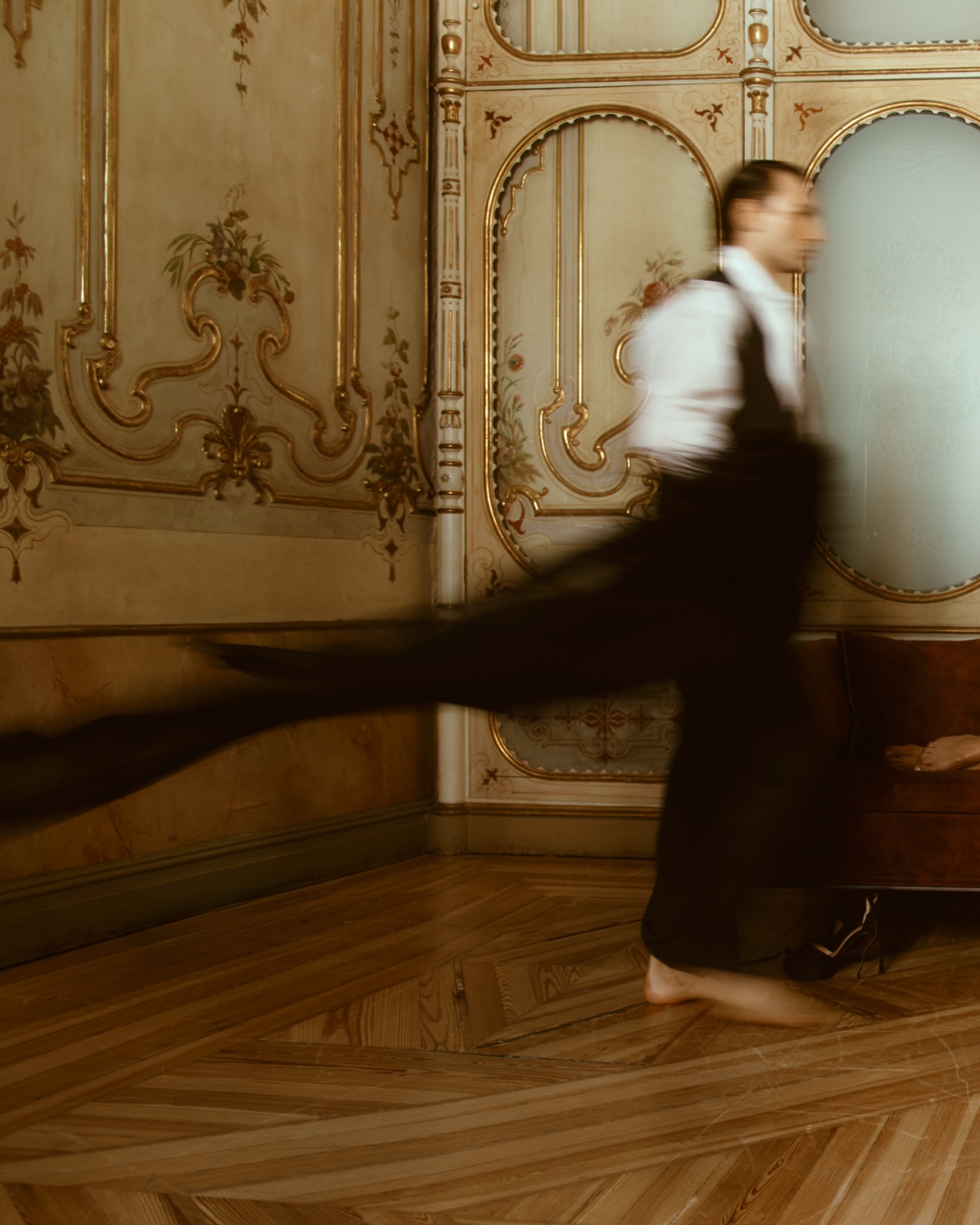 The butler crossing an ornate room